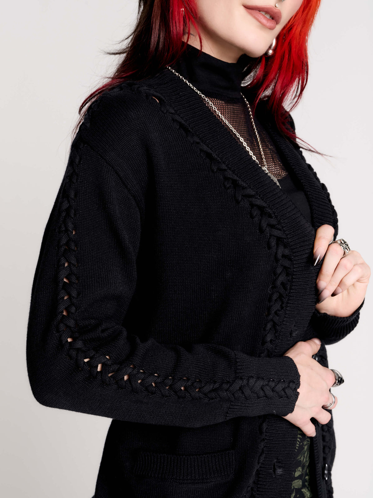 a black knit cardigan with braided details