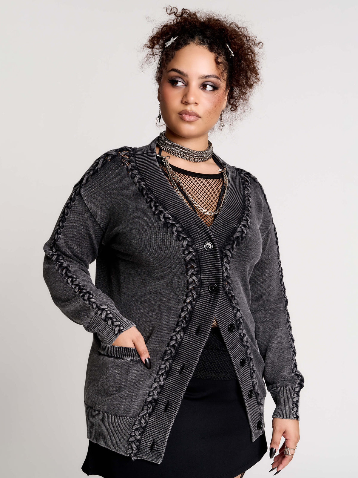 a dark gray textured cardigan with braided details