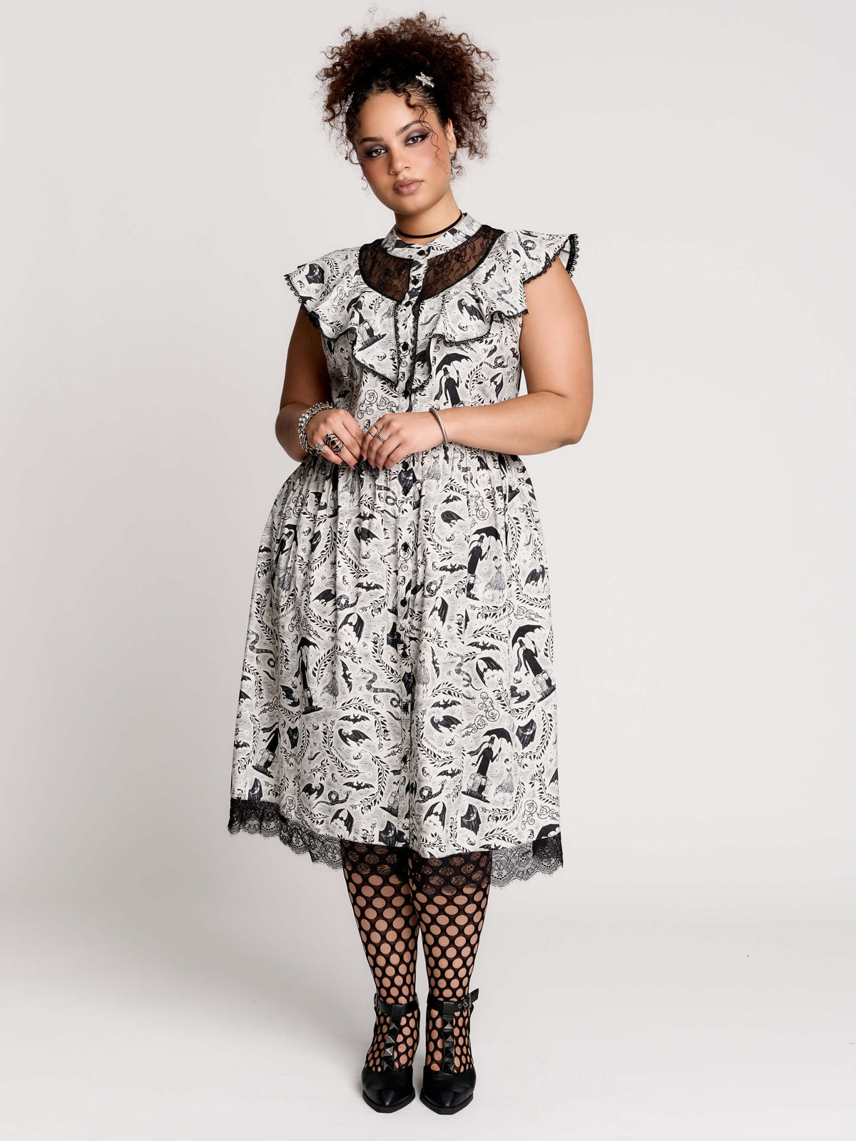 black and white gothic-style dress with a bird pattern, lace trim, and a high ruffled collar