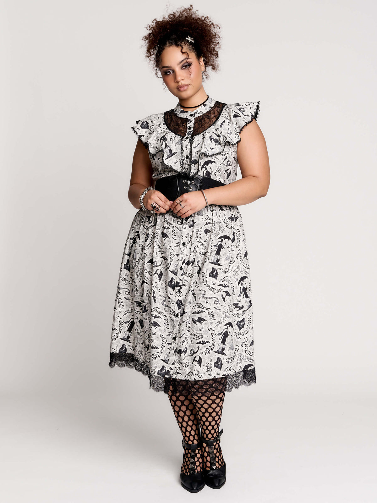 black and white gothic-style dress with a bird pattern, lace trim, and a high ruffled collar