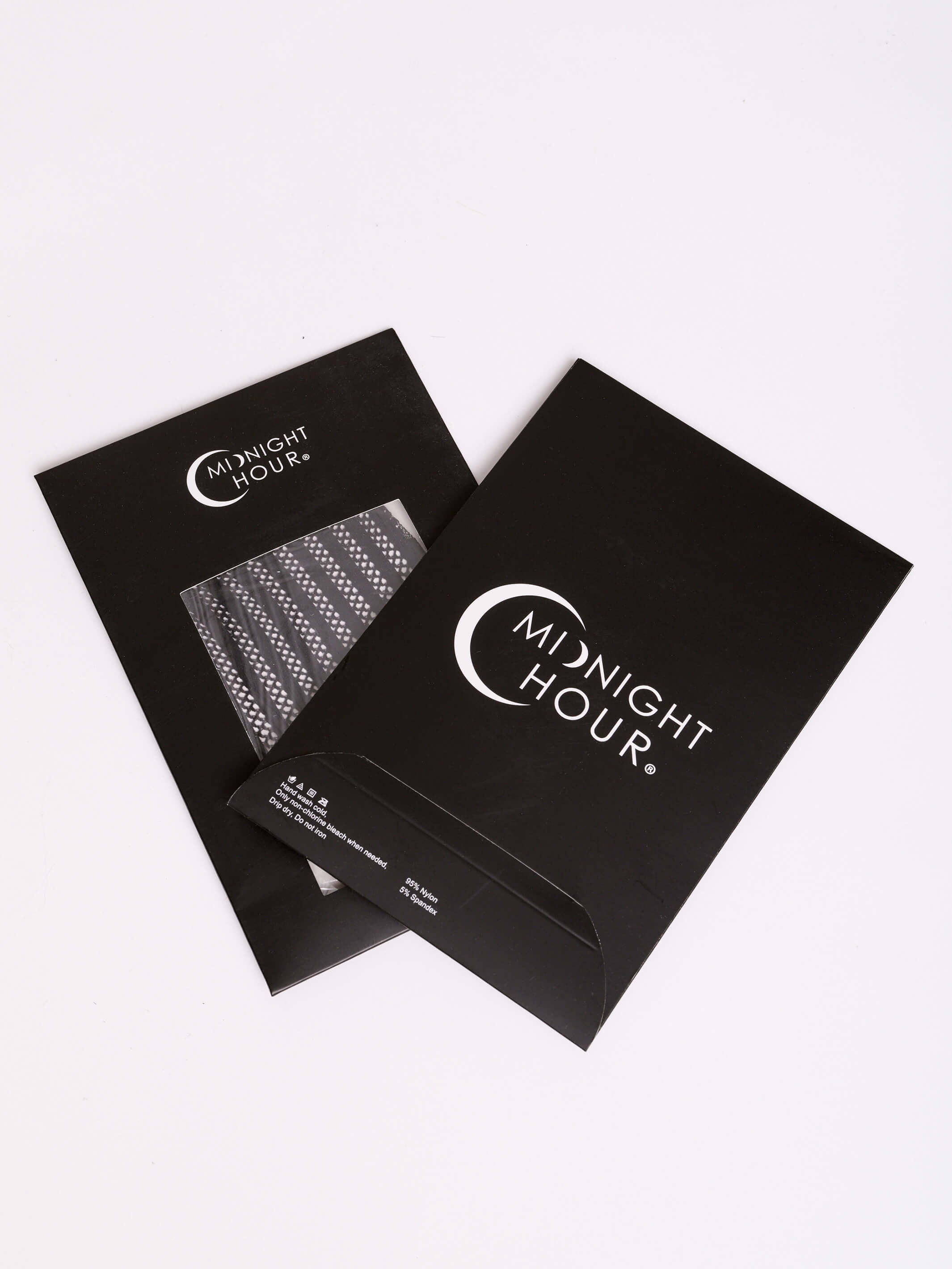 Two black Midnight Hour product boxes on a clean white background, with one box showing a clear window revealing a textured item inside.