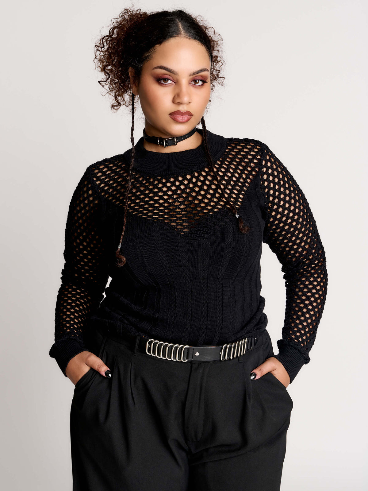 Fishnet Sweetheart Rib Sweater, a black long-sleeve top with a fitted rib-knit body and fishnet across the upper chest, shoulders, upper back and sleeves, giving a “sweetheart” illusion while keeping the sleek silhouette sleek.