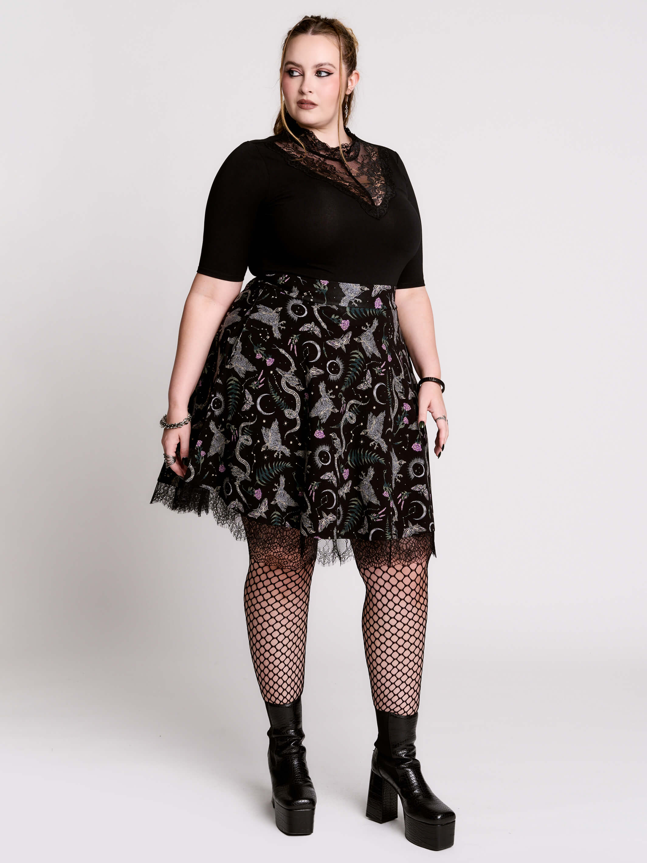 A black flared skirt featuring a gray and purple gothic print with lace hem.
