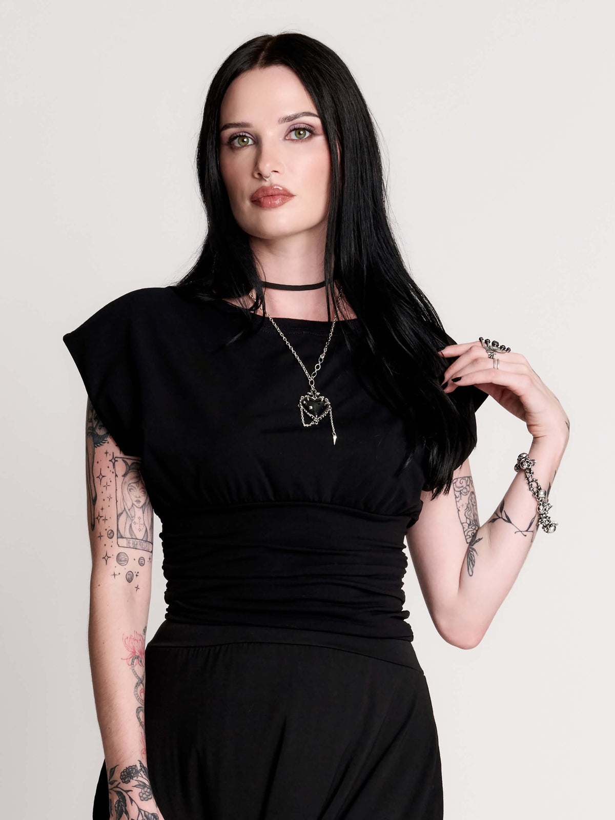 short sleeve top with a softly draped silhouette and a flattering, cinched waist.