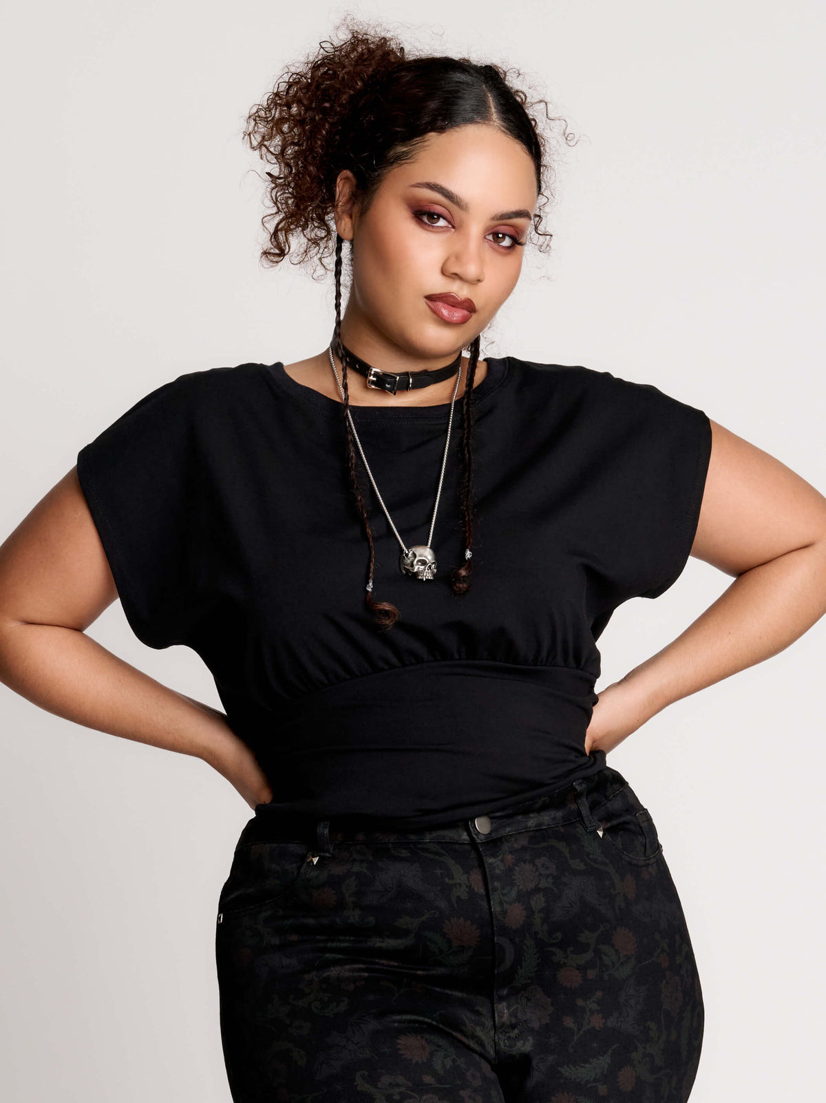 short sleeve top with a softly draped silhouette and a flattering, cinched waist.