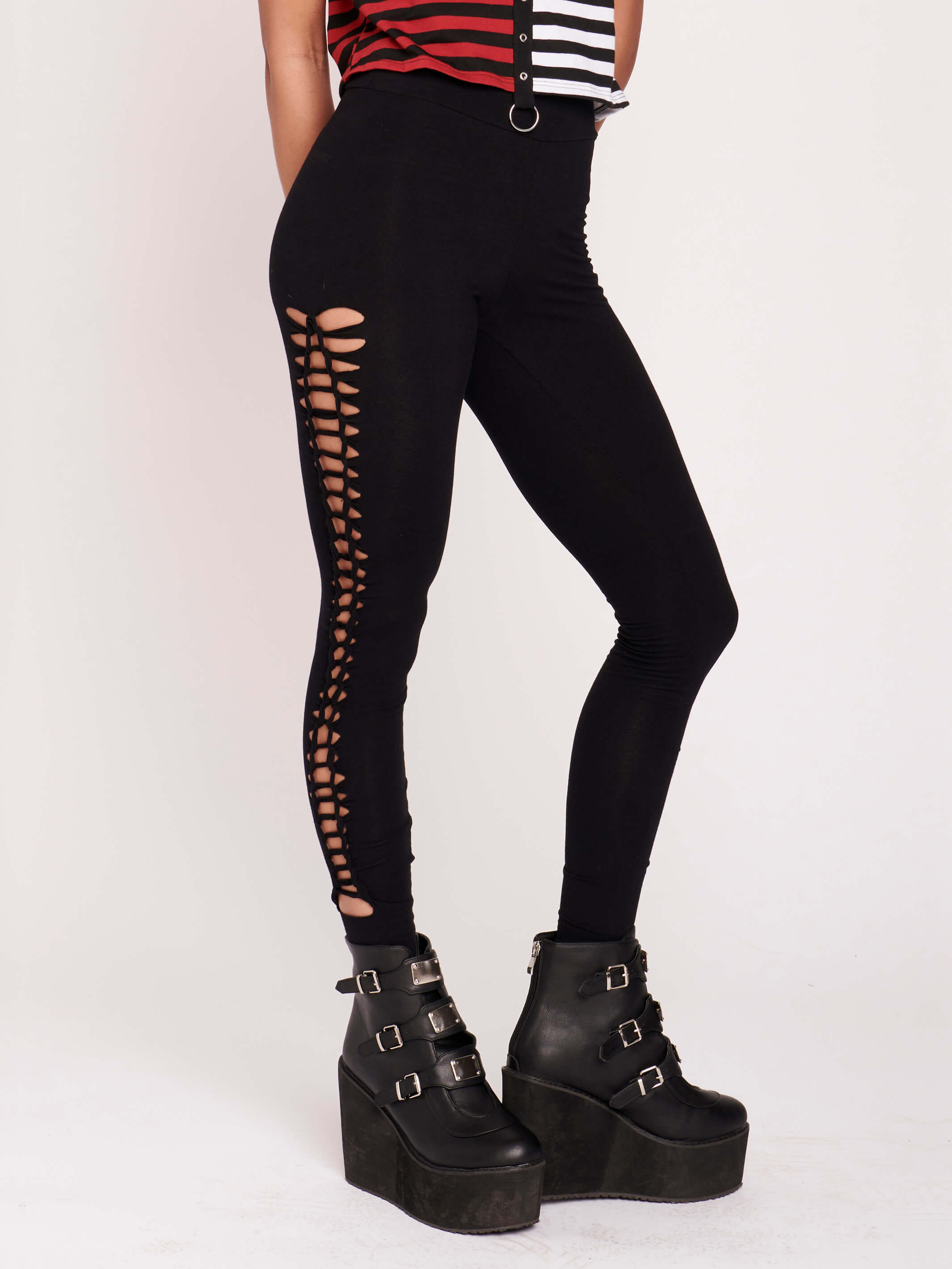 Stretchy cotton spandex leggings with slashed and braided side details.