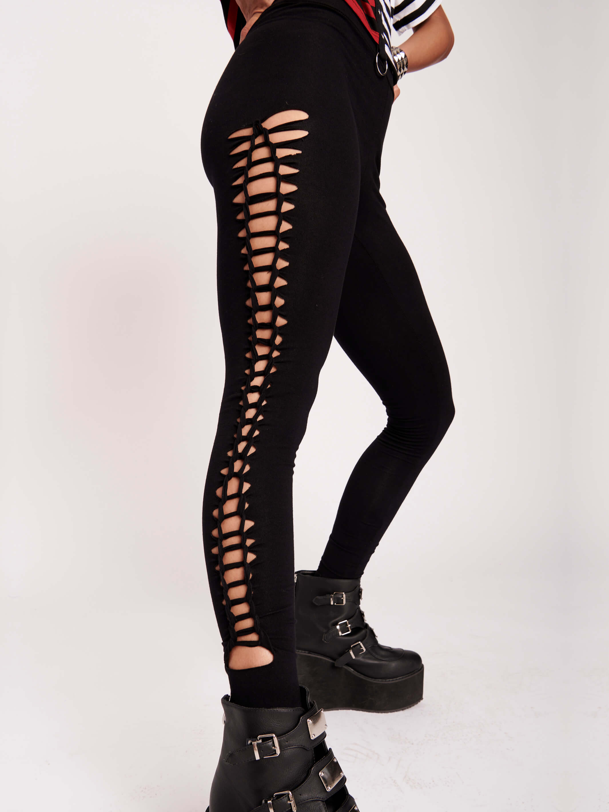Stretchy cotton spandex leggings with slashed and braided side details.