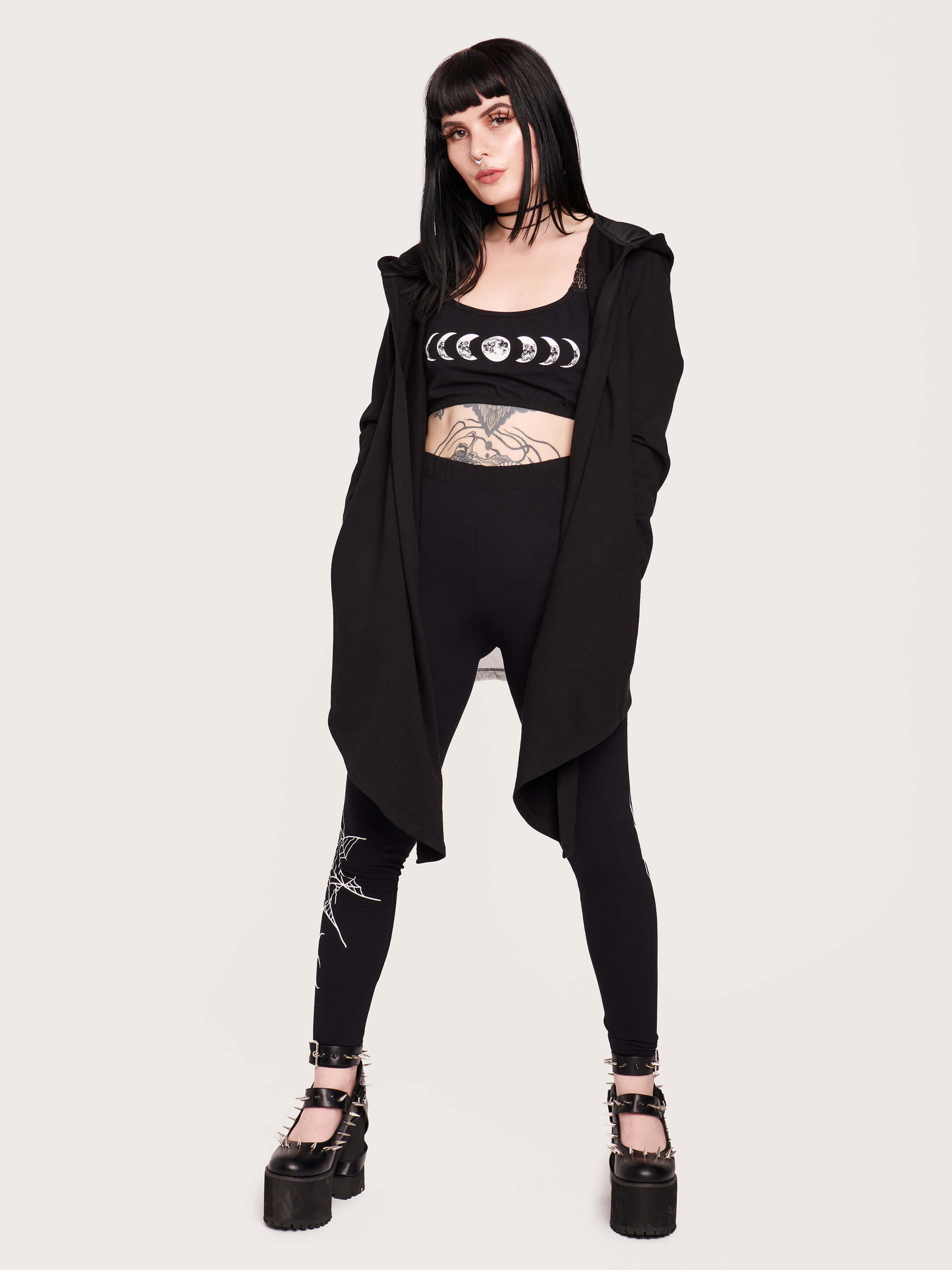 Tap into some voodoo vibes with this embroidered spinal back detail on our french terry hooded cloak. Crescent moon & rose embroidery on the front. Assymetrical hem with pockets. Goth grunge fashion, alt girl fashion, goth clothing, summer goth, skull top, goth punk top, egirl fashion, emo fashion.