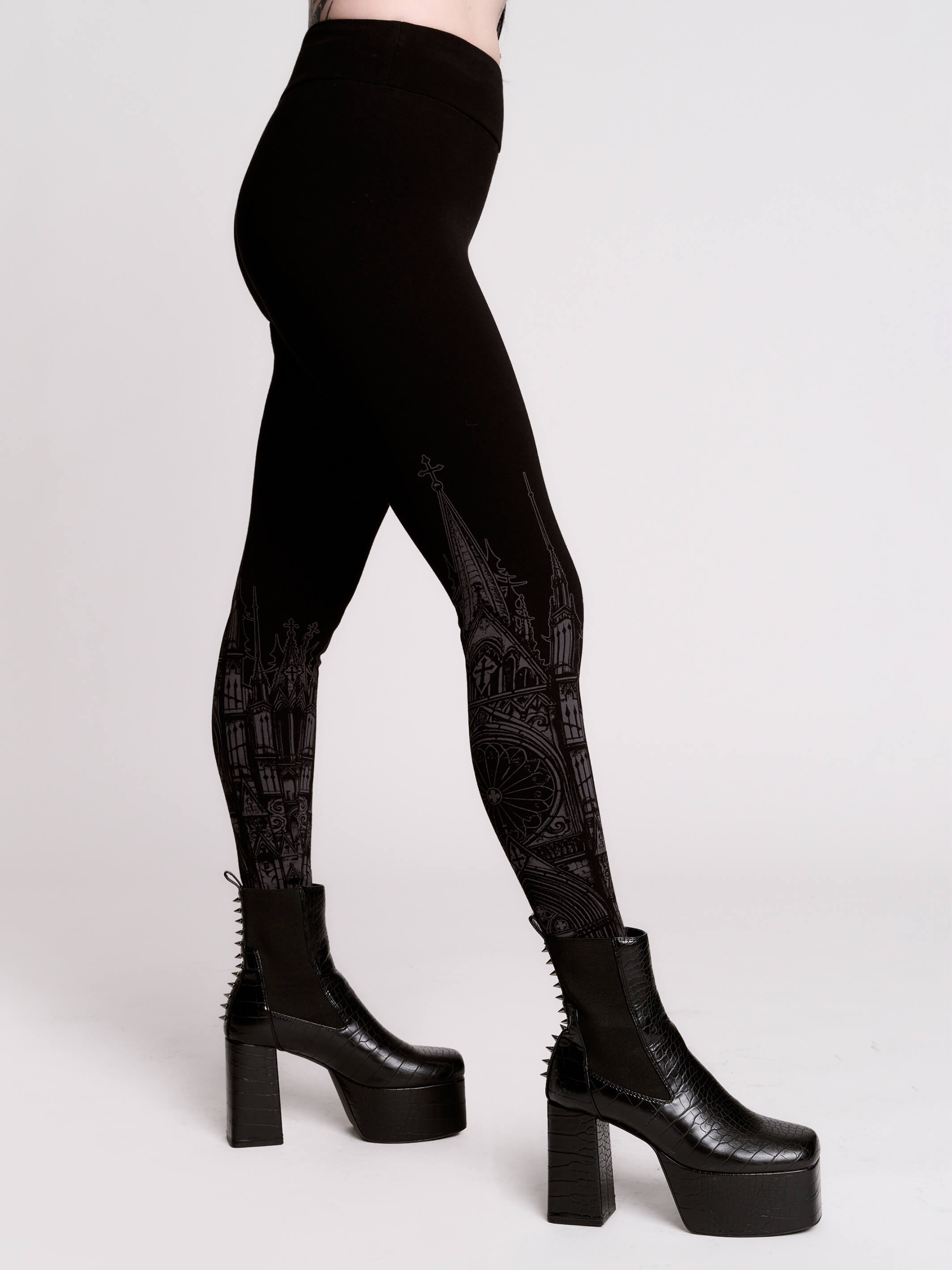 Black leggings with a dark gray gothic cathedral line-art print down the legs.