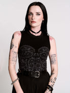 A black sleeveless top with a printed floral lace corset in light grey.