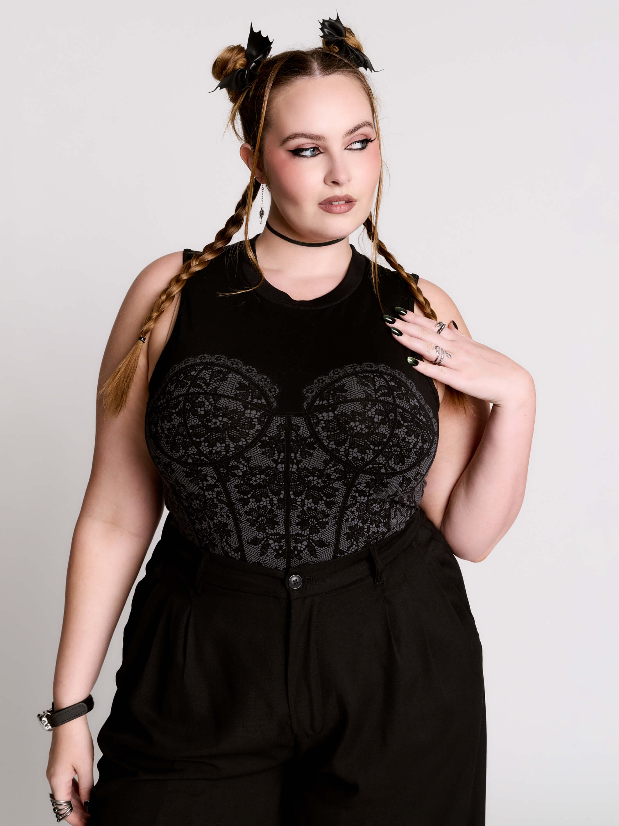 A black sleeveless top with a printed floral lace corset in light grey.
