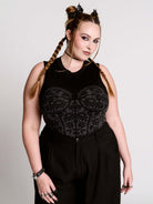 A black sleeveless top with a printed floral lace corset in light grey.