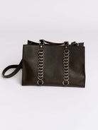 Black handbag with chain details on a light gray background
