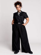 black short-sleeve blouse with white embroidered bat on collar and black lace trim