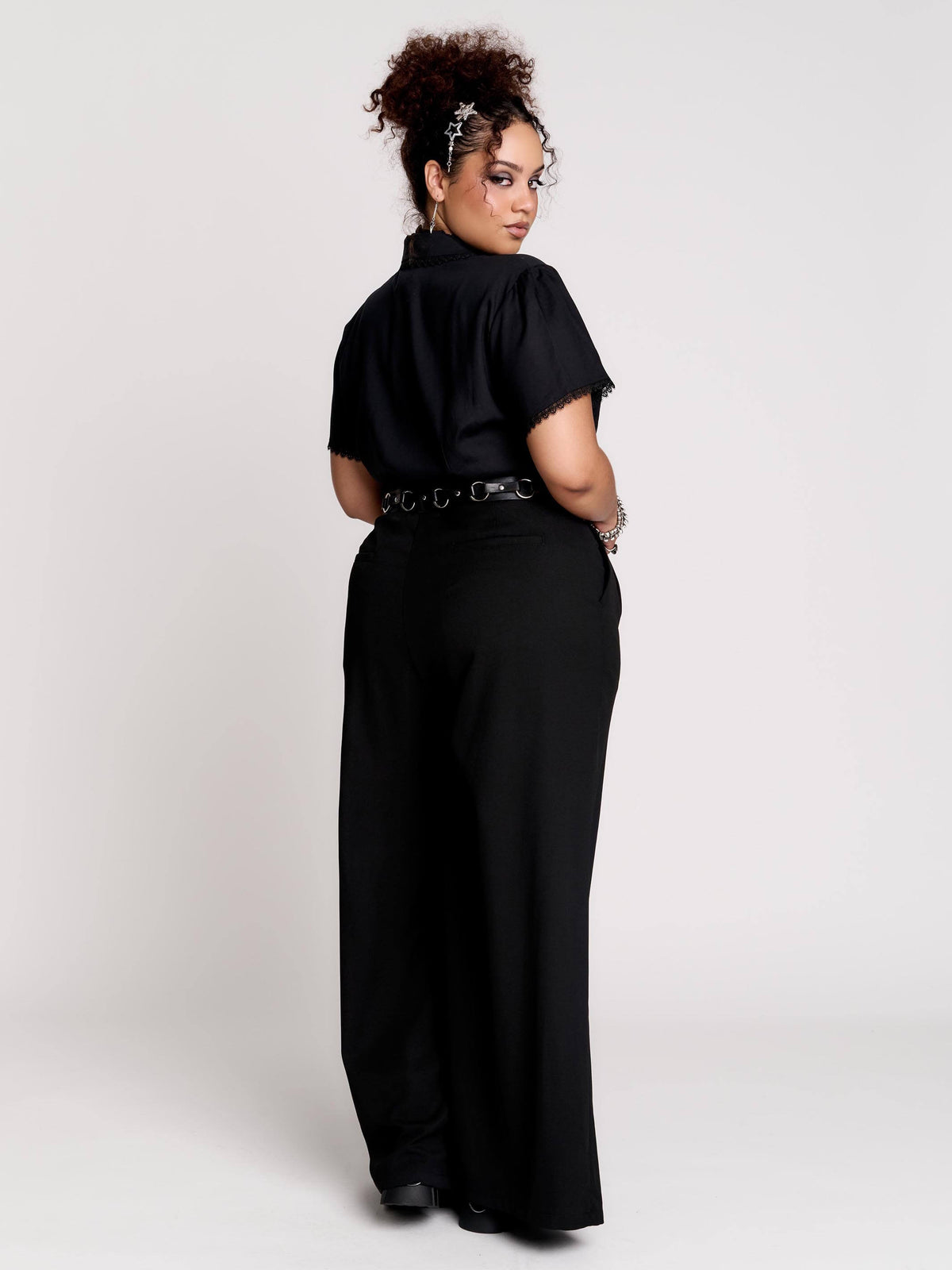 black short-sleeve blouse with white embroidered bat on collar and black lace trim