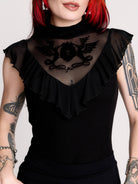 a black sheer mock-neck top with a black graphic on the chest