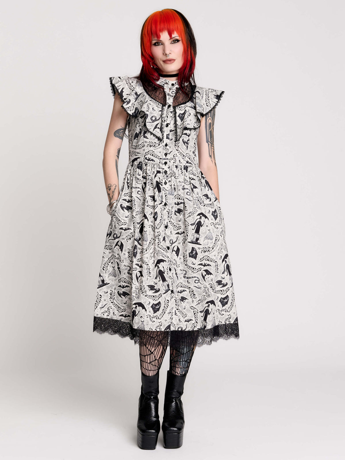 black and white gothic-style dress with a bird pattern, lace trim, and a high ruffled collar