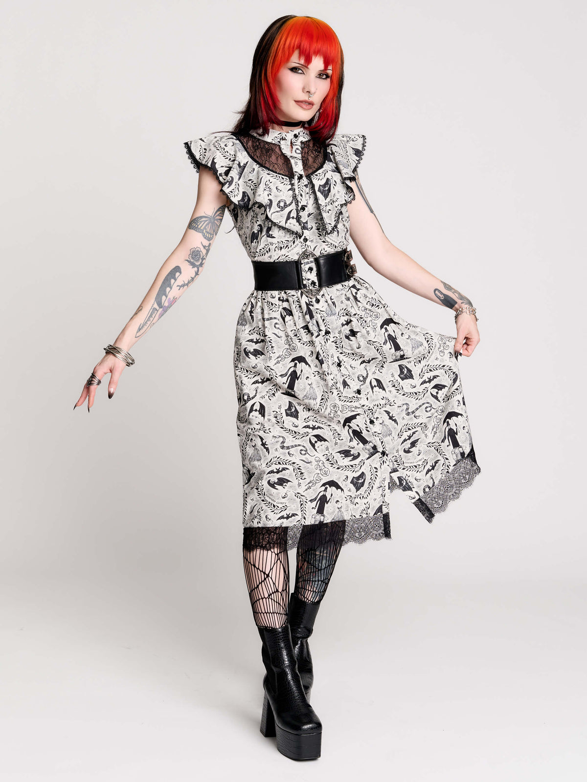 black and white gothic-style dress with a bird pattern, lace trim, and a high ruffled collar
