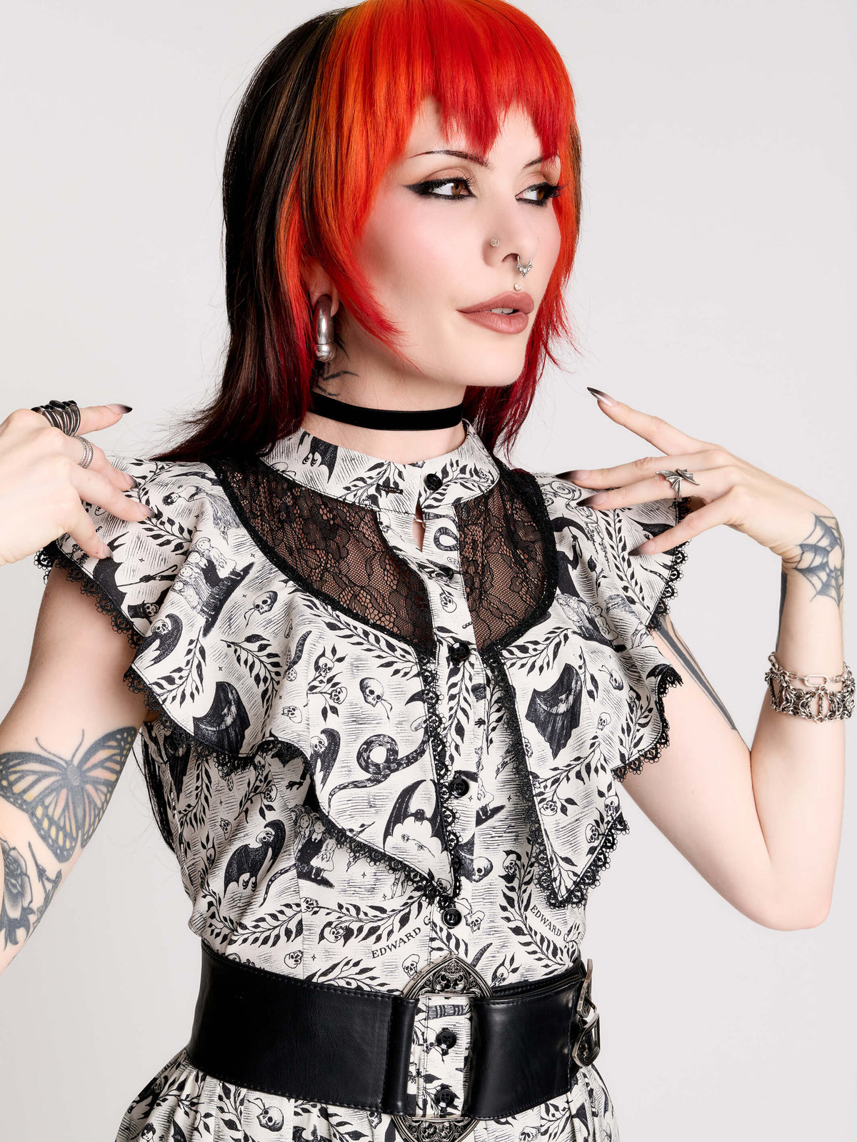 black and white gothic-style dress with a bird pattern, lace trim, and a high ruffled collar