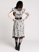 black and white gothic-style dress with a bird pattern, lace trim, and a high ruffled collar