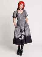short-sleeved gray and black gothic-style midi dress with a printed illustration of a woman and winged figure at the hem