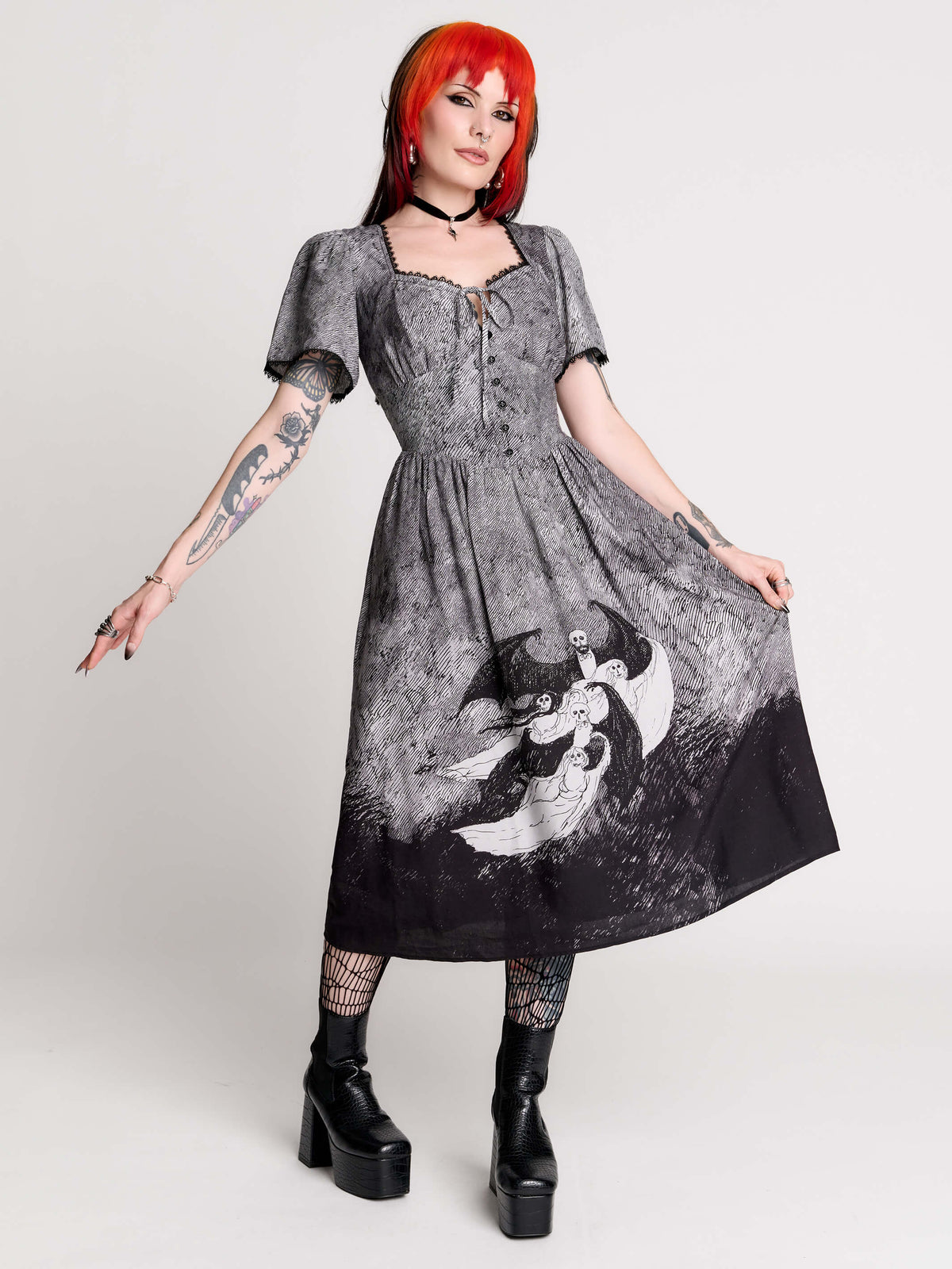 a short-sleeved gray and black gothic-style dress with a printed illustration of a winged figure