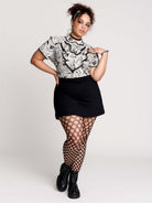  a black and white patterned ruffled blouse