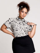  a black and white patterned ruffled blouse