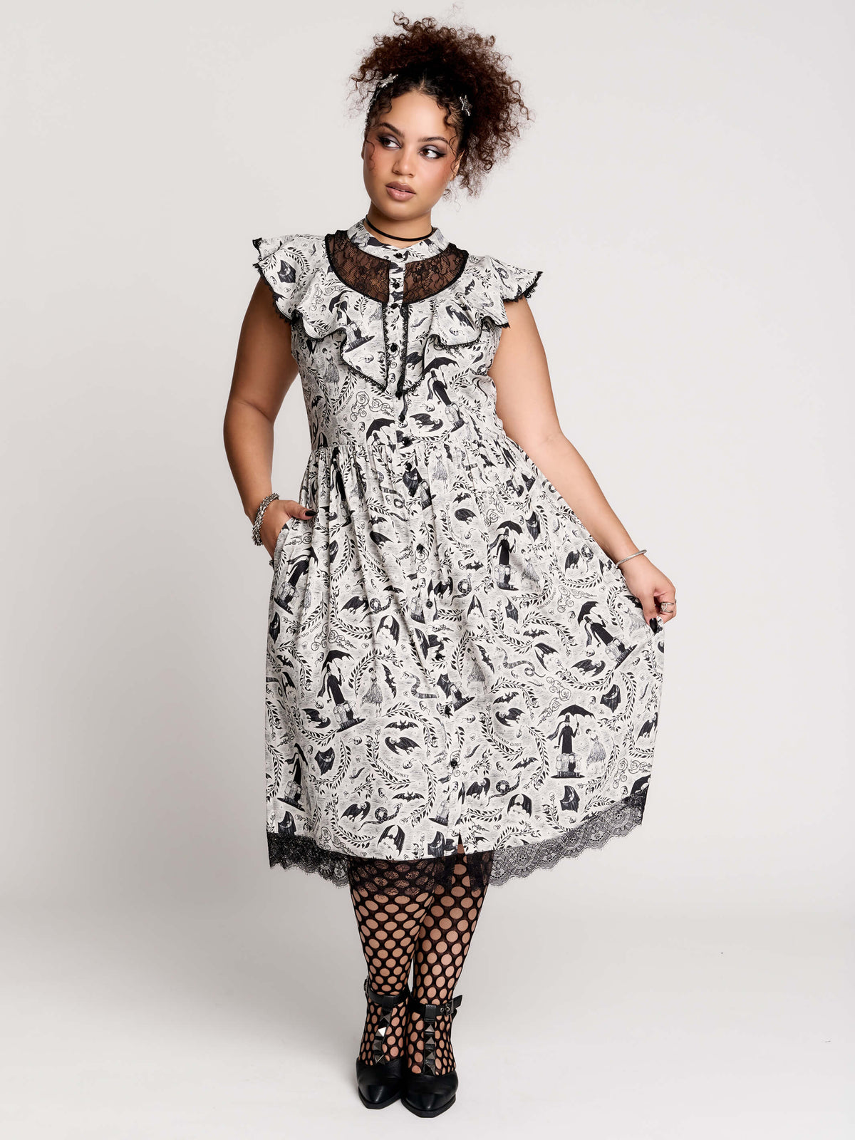 black and white gothic-style dress with a bird pattern, lace trim, and a high ruffled collar