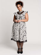 black and white gothic-style dress with a bird pattern, lace trim, and a high ruffled collar