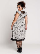 black and white gothic-style dress with a bird pattern, lace trim, and a high ruffled collar
