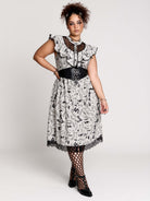 black and white gothic-style dress with a bird pattern, lace trim, and a high ruffled collar