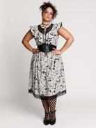 black and white gothic-style dress with a bird pattern, lace trim, and a high ruffled collar