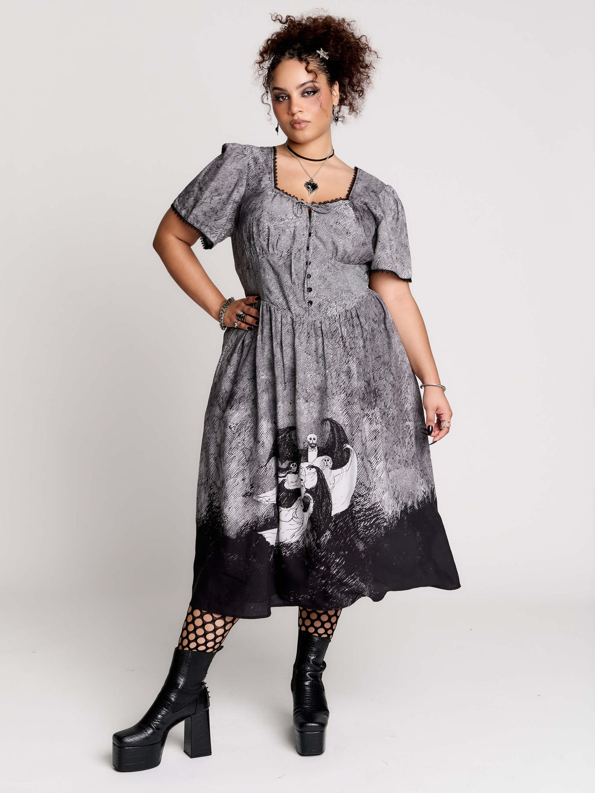 short-sleeved gray and black gothic-style midi dress with a printed illustration of a woman and winged figure at the hem