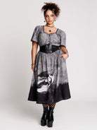 short-sleeved gray and black gothic-style midi dress with a printed illustration of a woman and winged figure at the hem