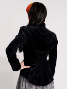 black velvet jacket with a black-and-white patterned lining and back lace up detail