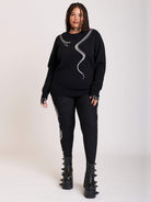 sweater with skeleton snake detail around neck.