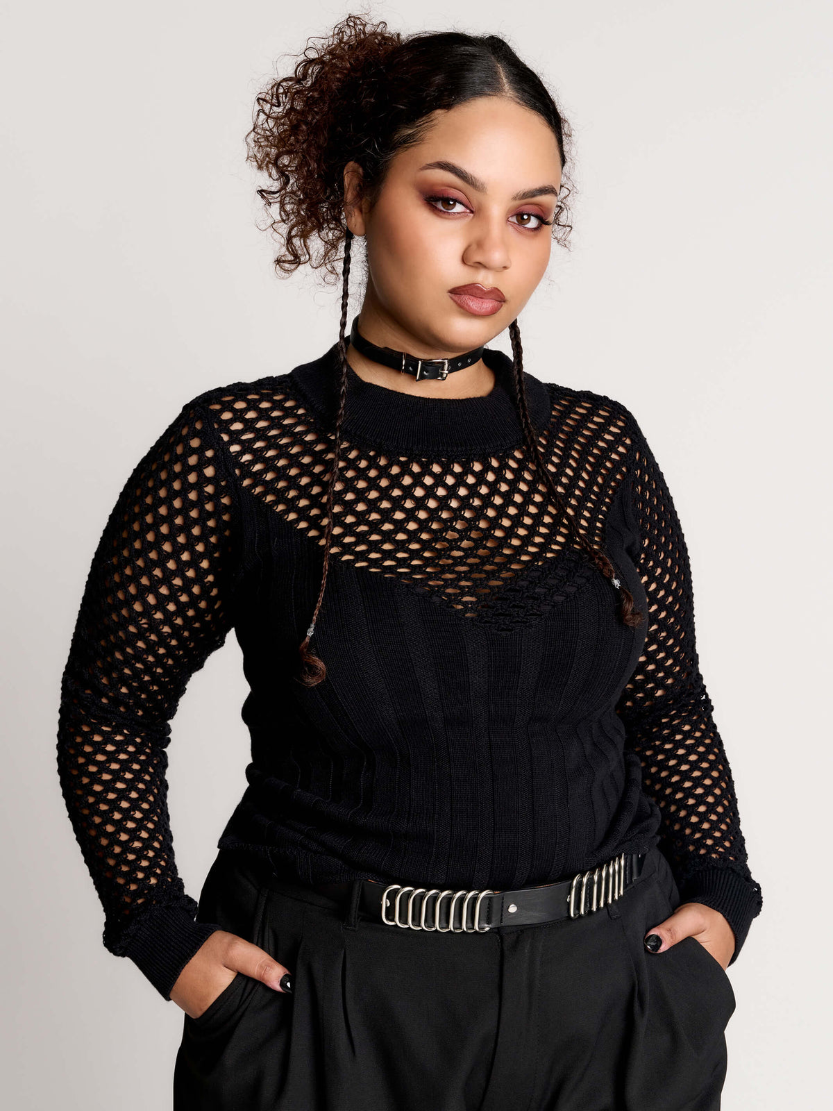 Fishnet Sweetheart Rib Sweater, a black long-sleeve top with a fitted rib-knit body and fishnet across the upper chest, shoulders, upper back and sleeves, giving a  “sweetheart” illusion while keeping the sleek silhouette sleek.