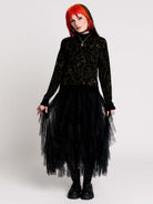 a black long-sleeve top with an intricate olive green forest findings pattern