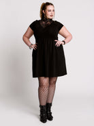 A black short-sleeve dress with a lace V-neckline.