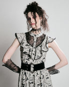 black and white gothic-style dress with a bird pattern, lace trim, and a high ruffled collar