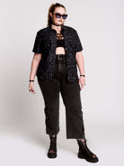 short-sleeve button-down that mixes crisp classic shirting with dark, gothic illustration. 