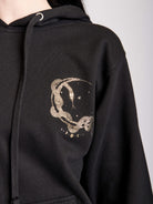 Black hoodie with gold moon tarot card graphic