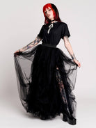 a voluminous layered black tulle skirt. 