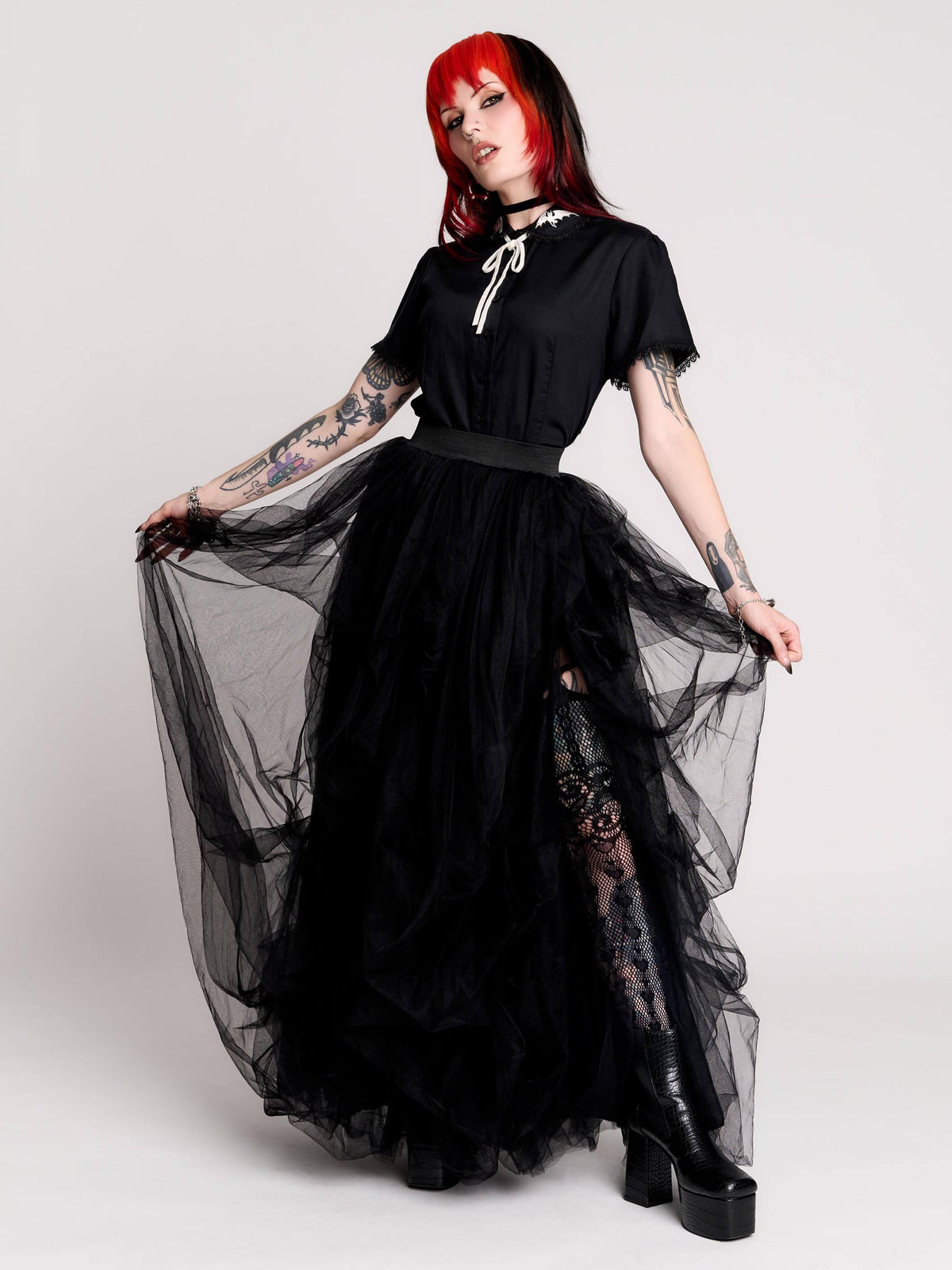 a voluminous layered black tulle skirt. 