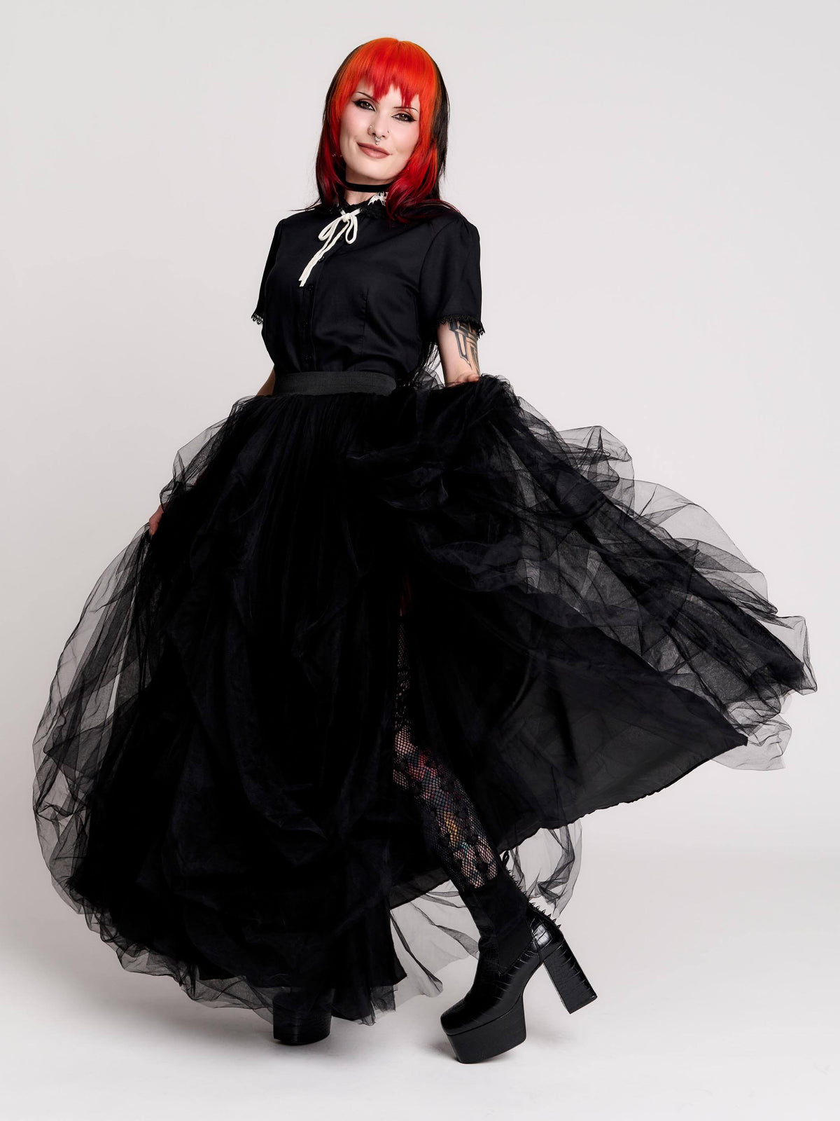 a voluminous layered black tulle skirt. 