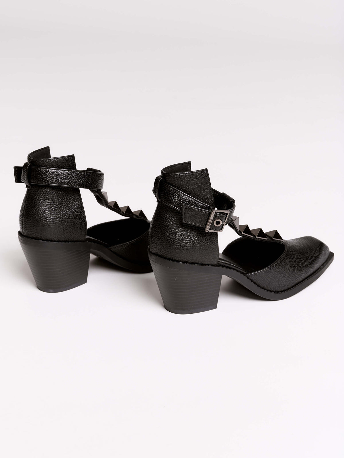 A pair of black leather ankle-strap block-heel shoes with pointed toes and silver pyramid stud embellishments.