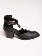 A pair of black leather ankle-strap block-heel shoes with pointed toes and silver pyramid stud embellishments.