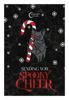A Halloween-themed greeting card design featuring a black bat holding a red and white candy cane against a black marbled background with white snowflakes. The text reads 'Midnight Hour' at the top and 'Sending You Spooky Cheer' at the bottom in red and white lettering.