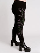 Black leggings with a detailed graphic print of a green fern, a purple flower, and a silver snake